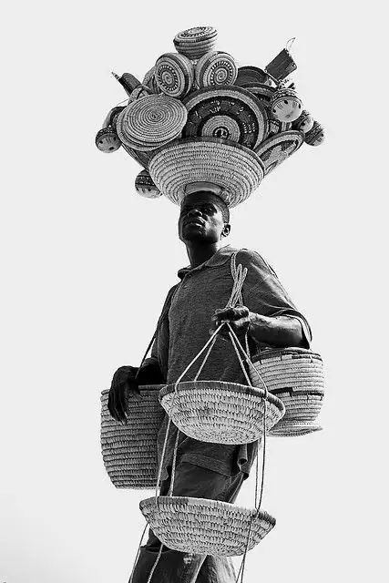 Assorted woven baskets carried by a market seller