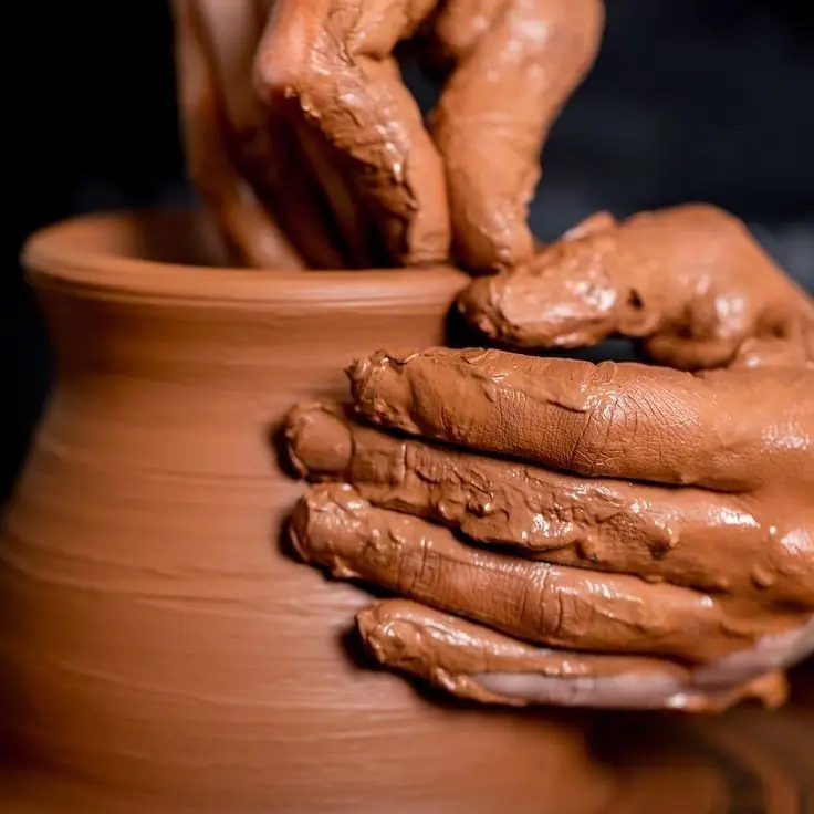 Artisan hands shaping pottery